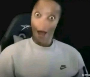 Warped-face gamer with bulging eyes and gaping mouth in total shock
