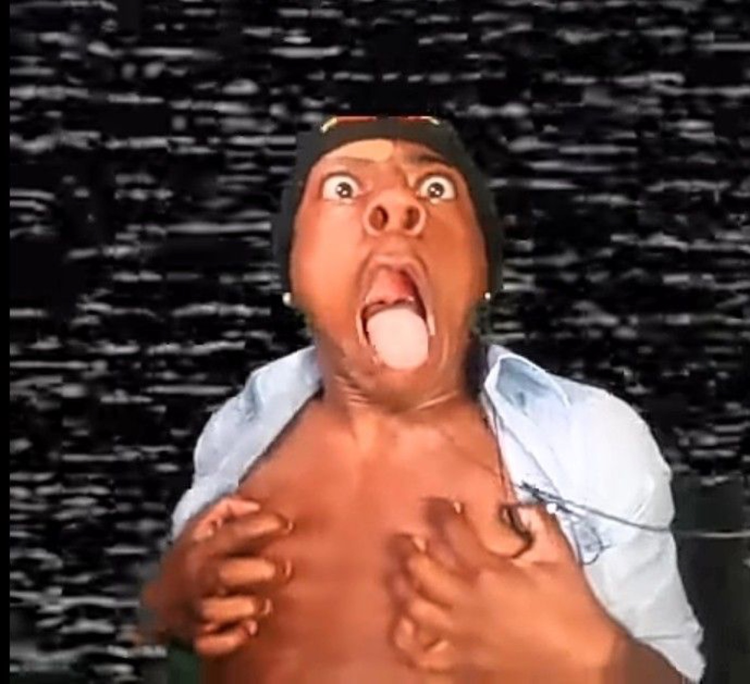 Man ripping open his shirt with his mouth wide open and tongue out in full chaos mode