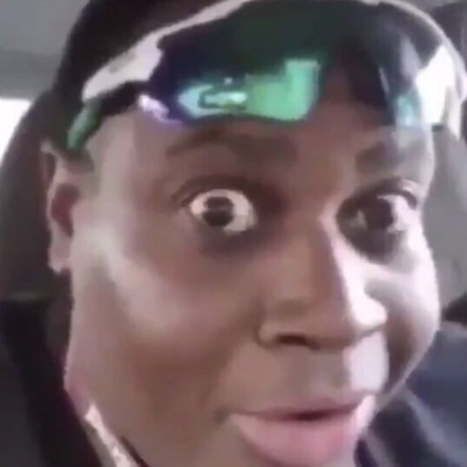Man in a car with sunglasses on his head, eyes bugged out in disbelief