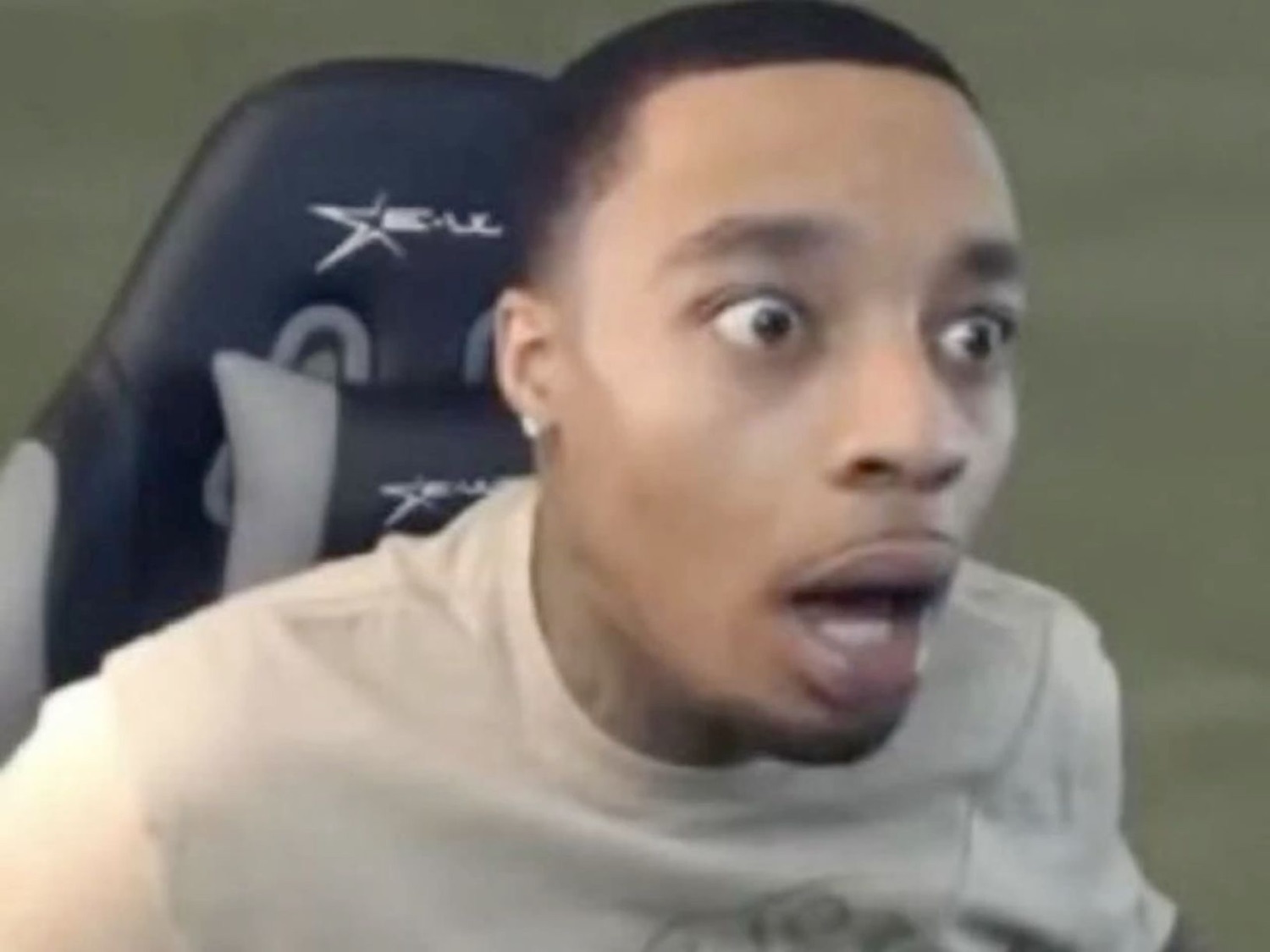Guy in a gaming chair with eyes bugged out and mouth wide open in total shock