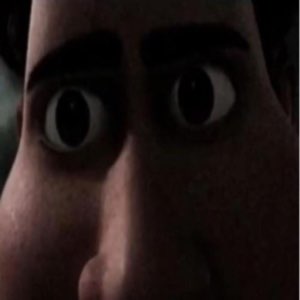 Extreme close-up of a wide-eyed animated face frozen in a dark, fearful stare