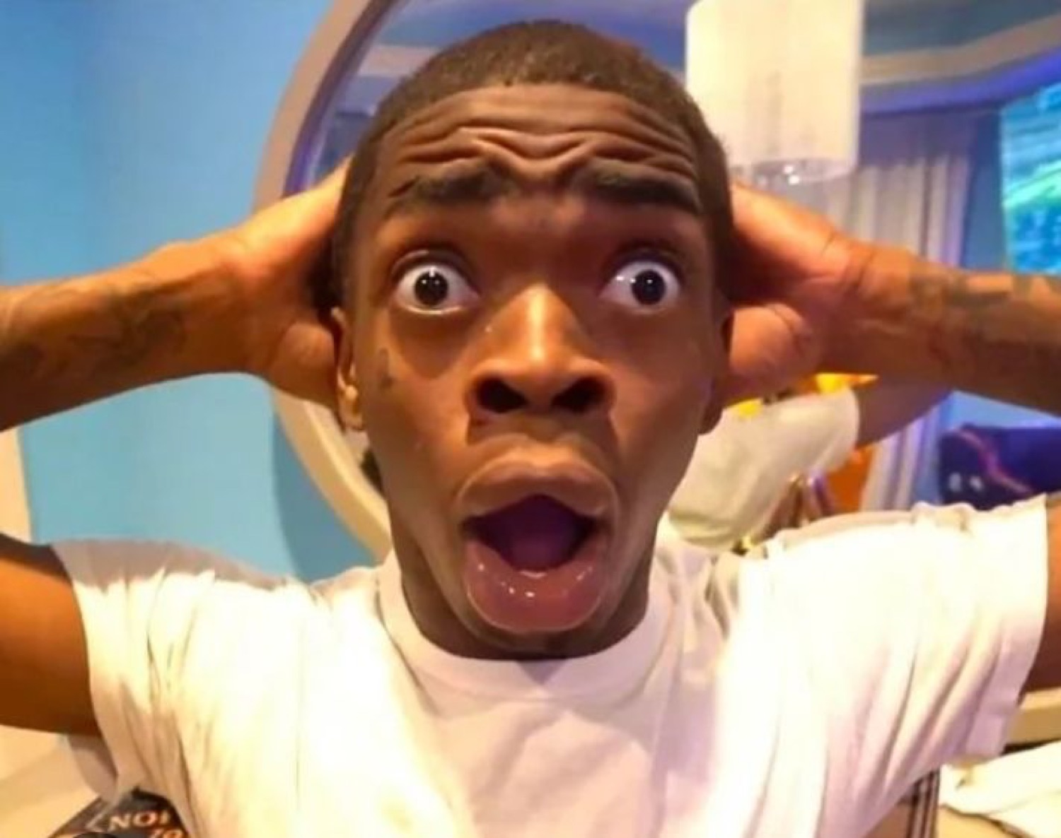 Guy gripping his head with a slack-jawed, bug-eyed look of pure shock