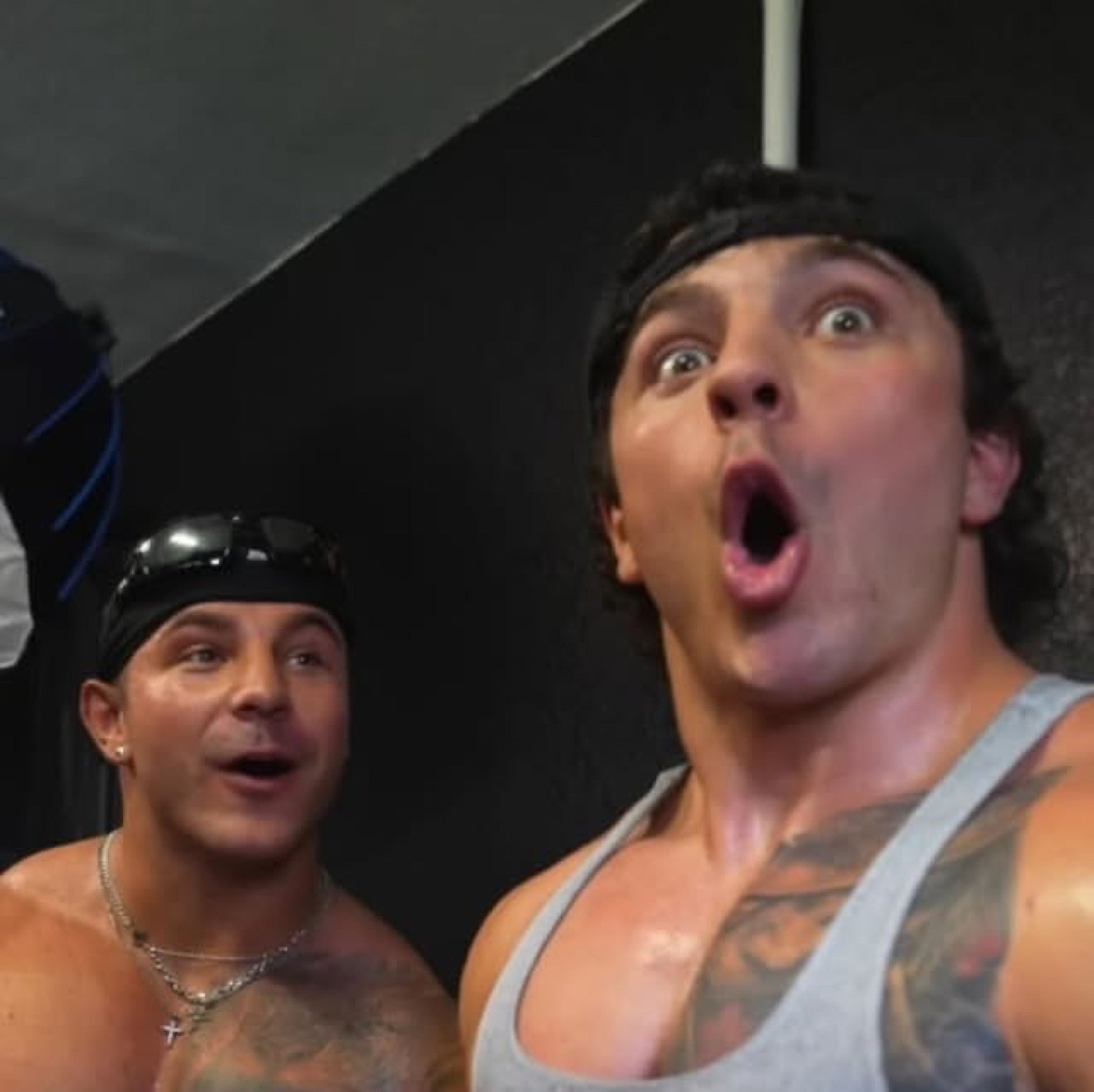 Two gym bros with wide eyes and dropped jaws