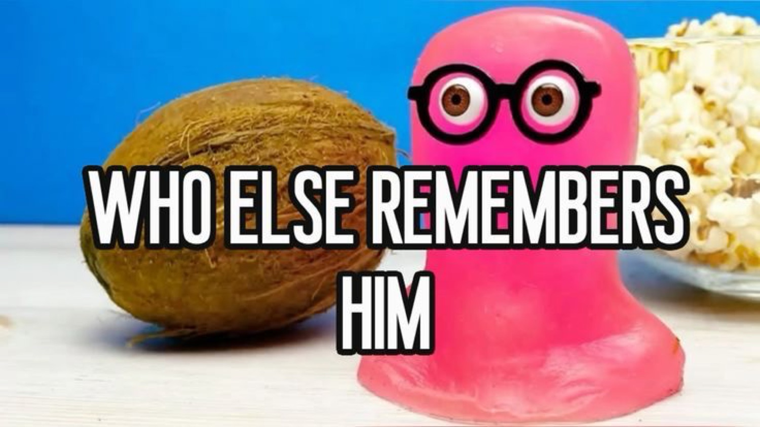 Pink toy blob in glasses next to a coconut: 'WHO ELSE REMEMBERS HIM'