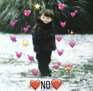 Little kid standing alone in the snow surrounded by heart emojis, captioned 'NO'