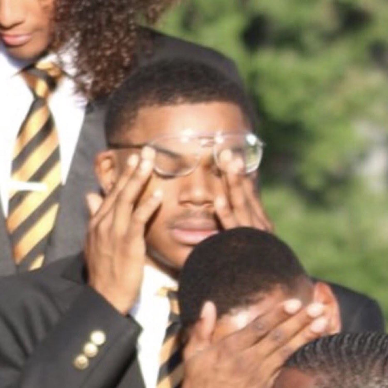 Group of guys in blazers covering their faces in secondhand embarrassment