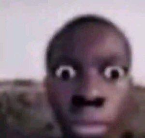 A blurry close-up of a person with eyes bugged out and mouth agape in total shock