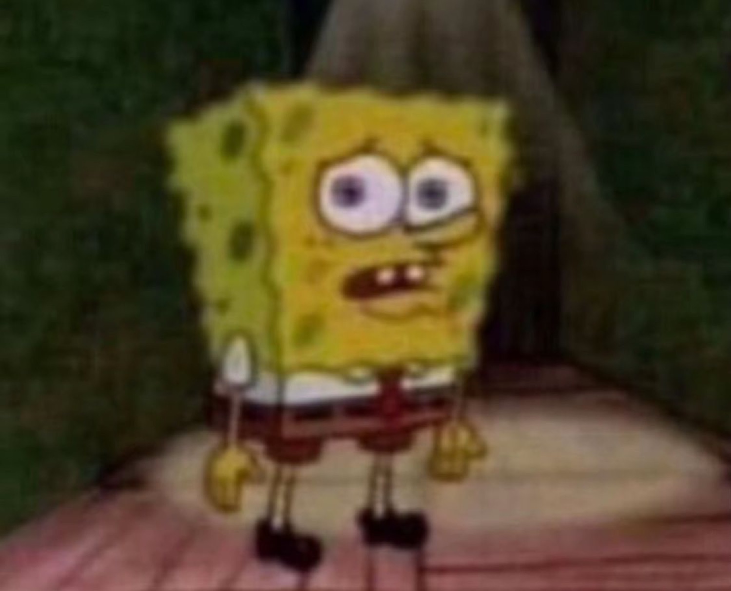 SpongeBob standing alone in a dark hallway looking small and nervously uncertain