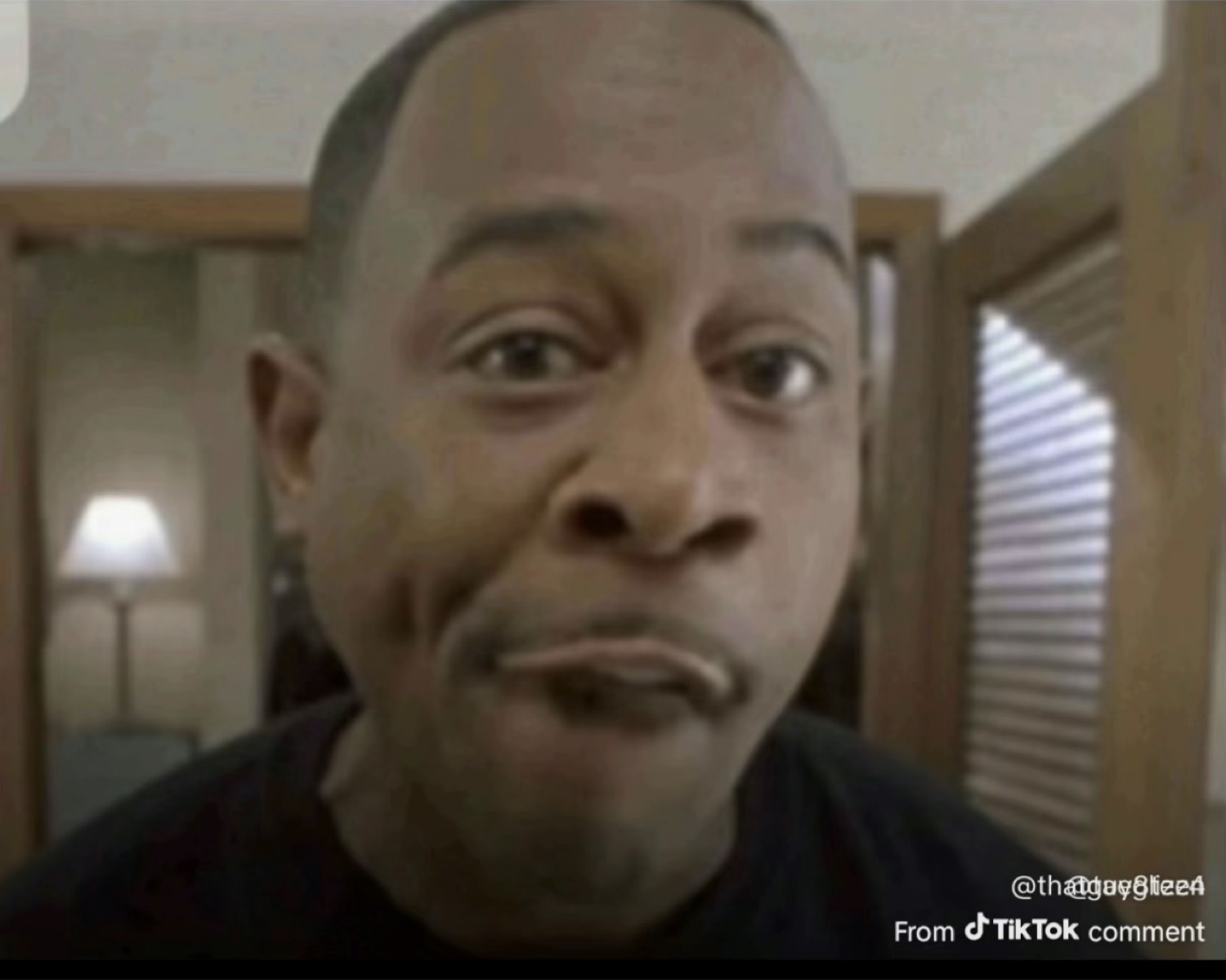 Man pursing his lips with a skeptical face