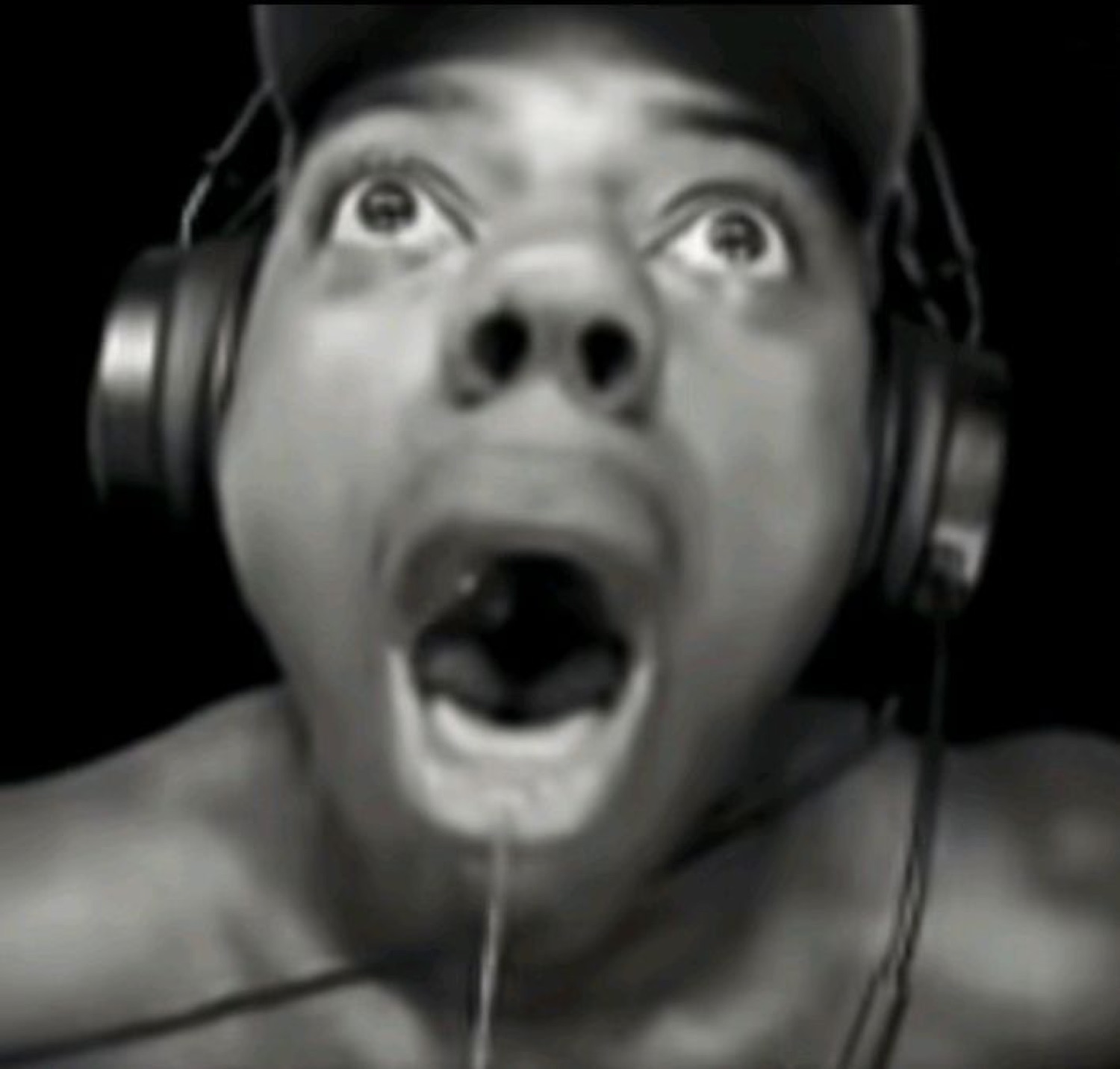 Person in headphones with mouth agape and eyes rolled up in total shock