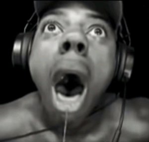 Person in headphones with mouth agape and eyes rolled up in total shock
