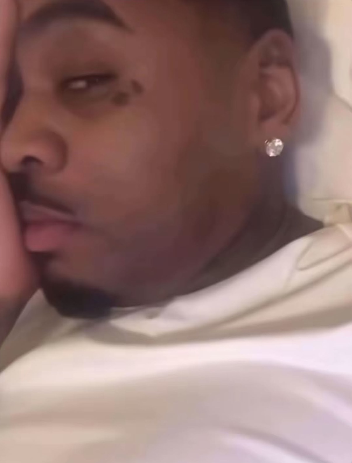Man lying on his side with a squished, unbothered face