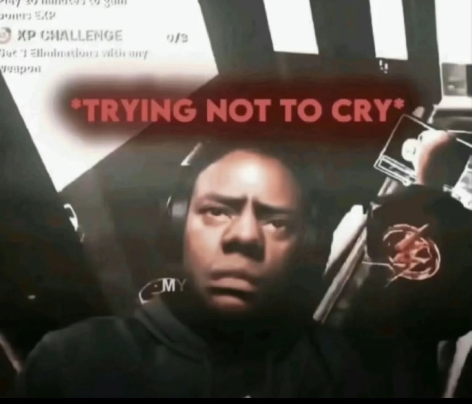 Gamer in a headset with a pained, teary face captioned '*trying not to cry*'