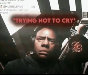 Gamer in a headset with a pained, teary face captioned '*trying not to cry*'