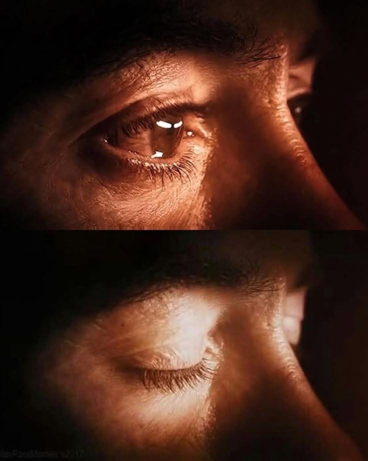 Extreme close-up of a person's eyes — one open and piercing, one closed — lit with deep amber light