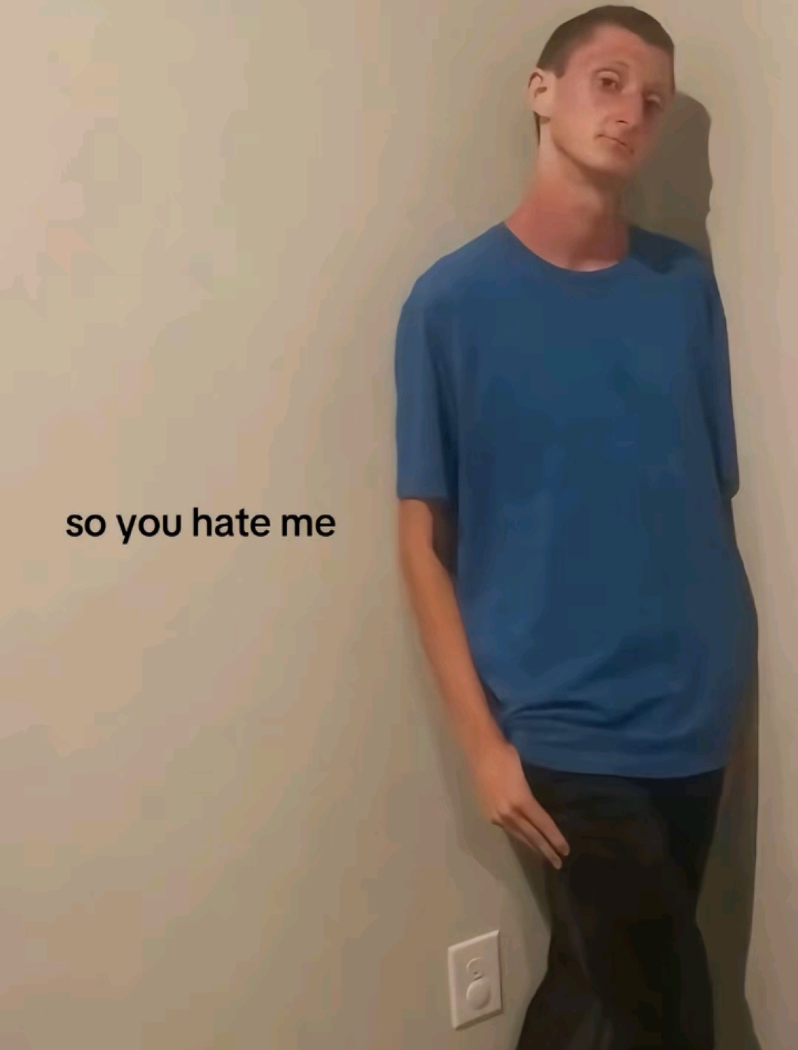 Teen leaning against a wall with a hurt look, captioned 'so you hate me'