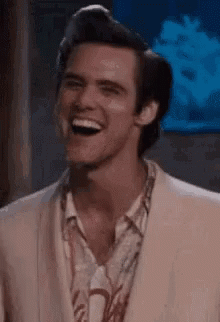 Jim Carrey as Ace Ventura laughing and giving a thumbs up