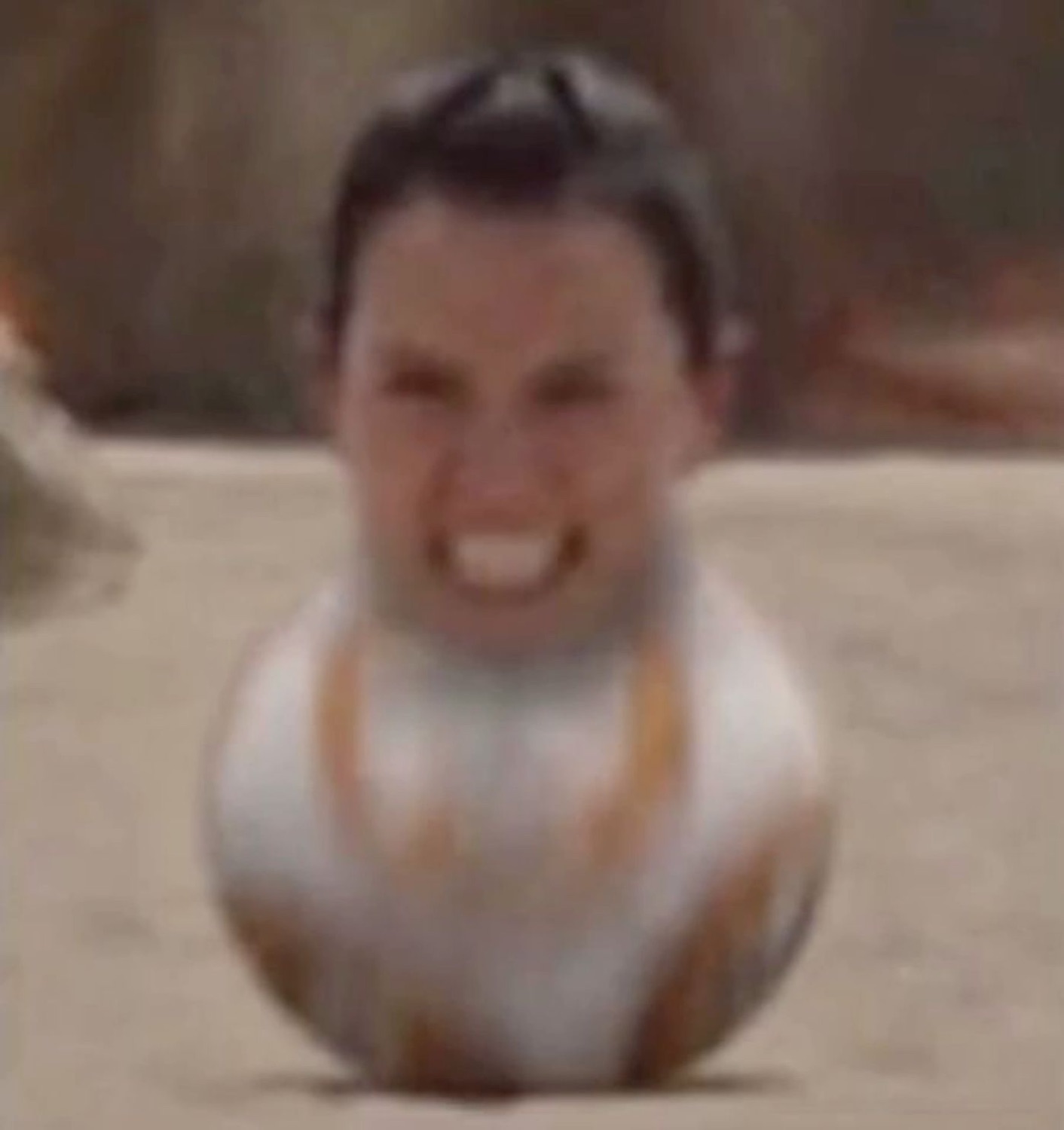 BB-8 with a grinning human face rolling toward the camera
