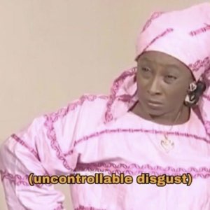 Woman in pink traditional dress giving a hard disgusted side-glance captioned '(uncontrollable disgust)'