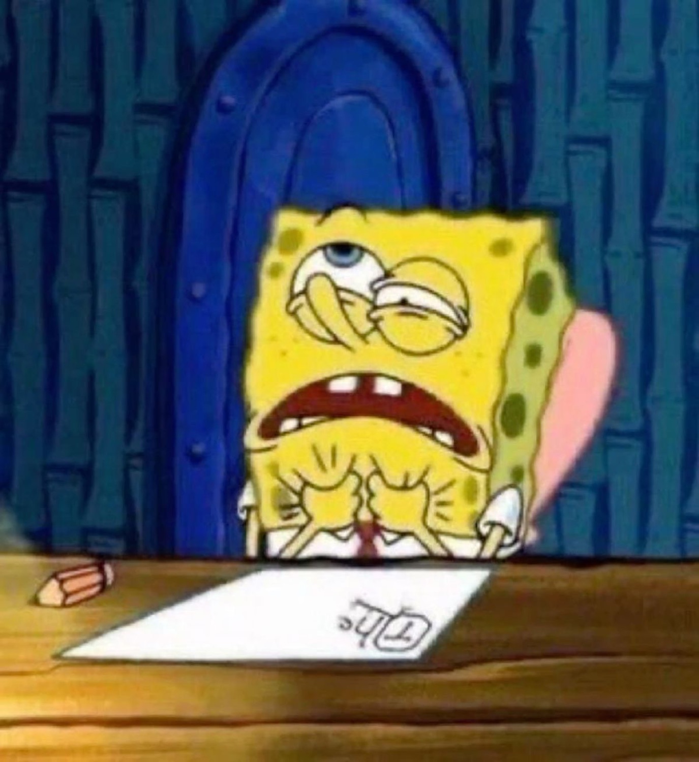 SpongeBob hunched over a blank paper looking absolutely overwhelmed and stressed