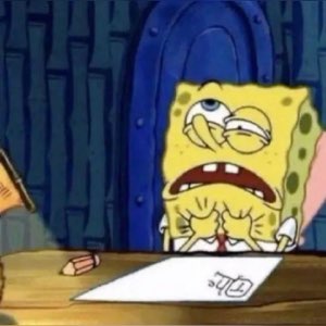 SpongeBob face-down on a desk looking completely broken and overwhelmed