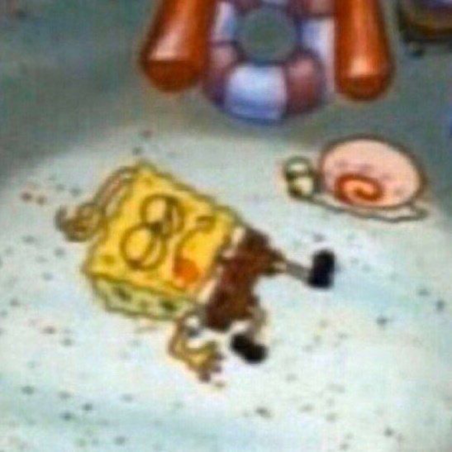 SpongeBob lying face-down on the floor in a crumpled defeated heap next to Gary