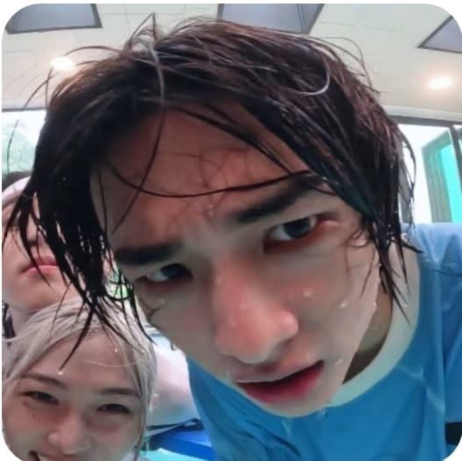 Soaking wet guy leaning into the camera with a flat, exhausted stare