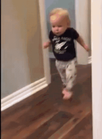 Toddler running away down a hallway