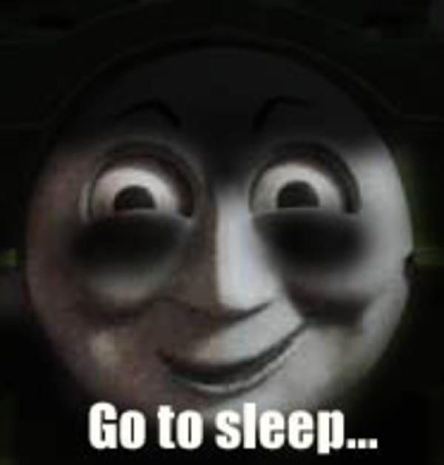 Darkened Thomas the Tank Engine grinning wide, captioned 'Go to sleep...'