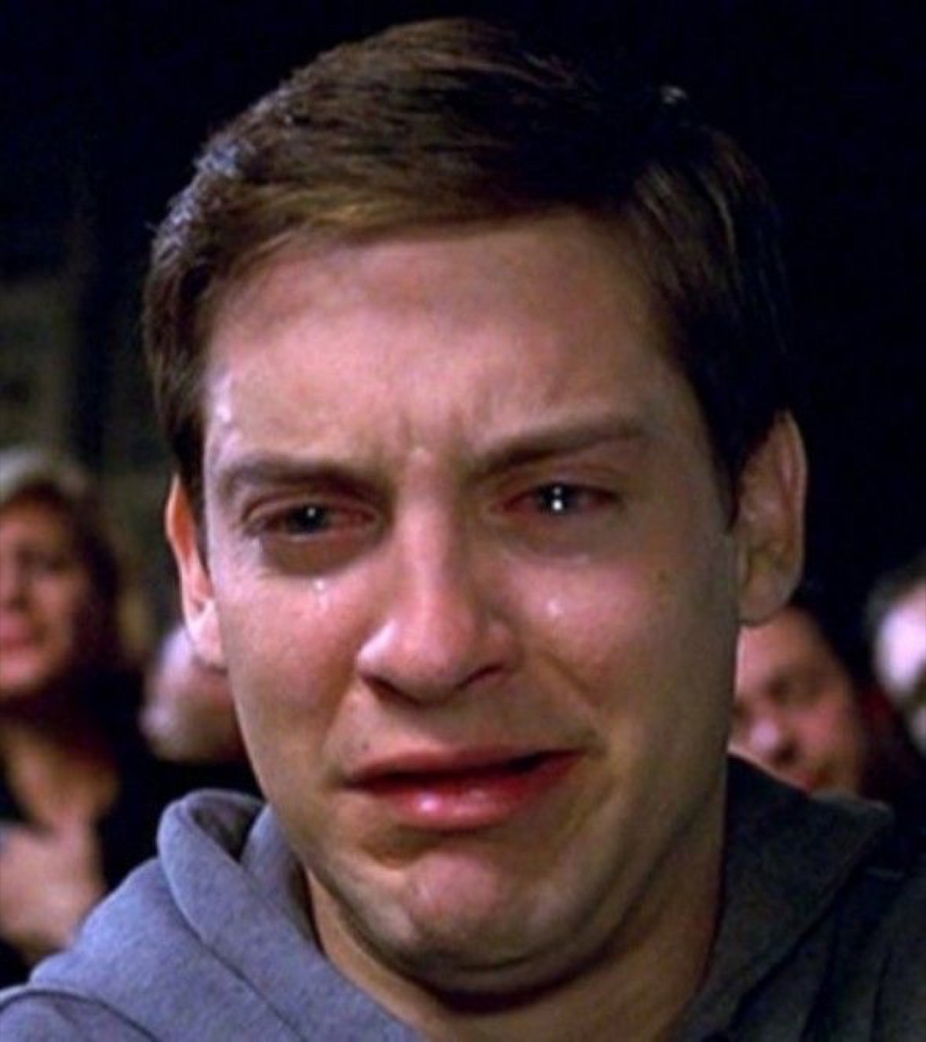 Peter Parker with teary eyes and a quivering lip, on the verge of full crying