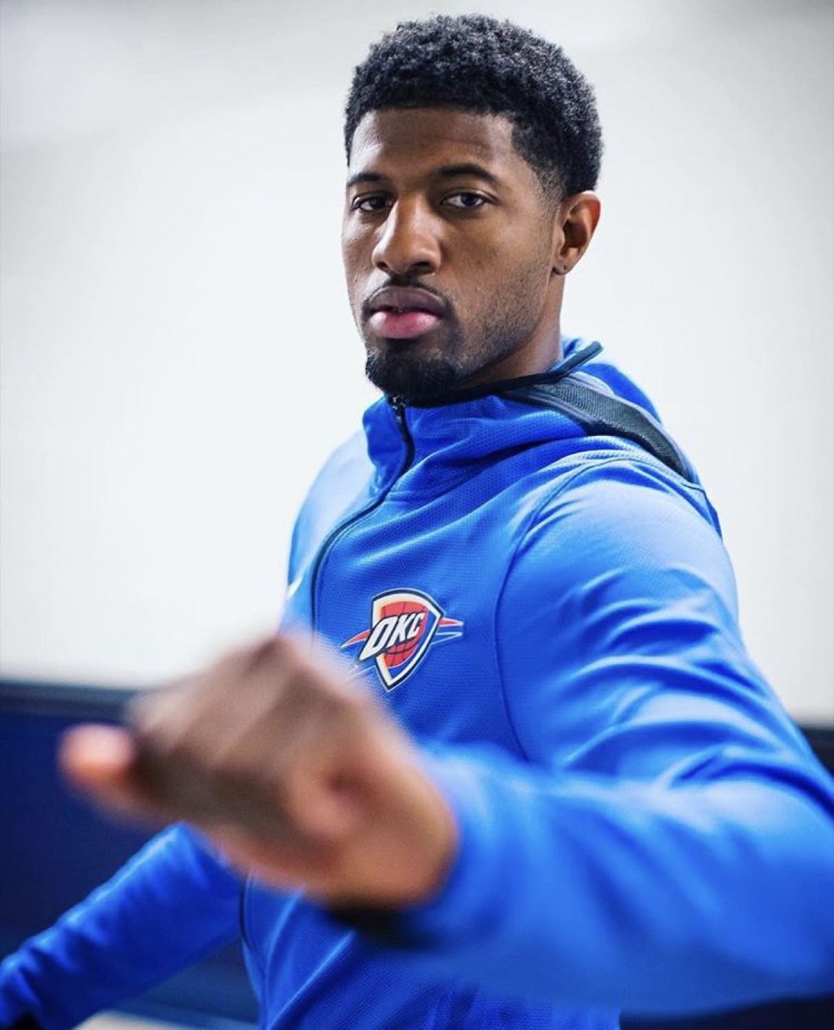 Paul George punching toward the camera