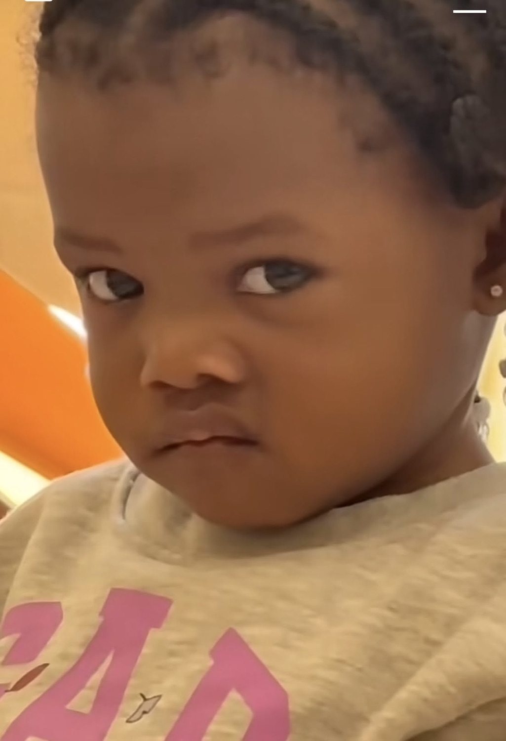 Toddler cutting a sharp, unimpressed side-eye off to the corner