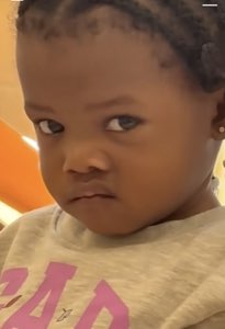 Toddler cutting a sharp, unimpressed side-eye off to the corner