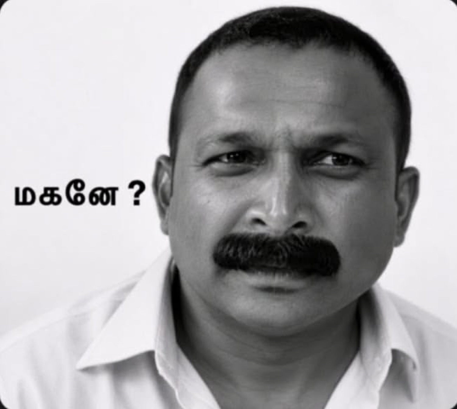 Black-and-white mustached man: 'மகனே ?' (son?)