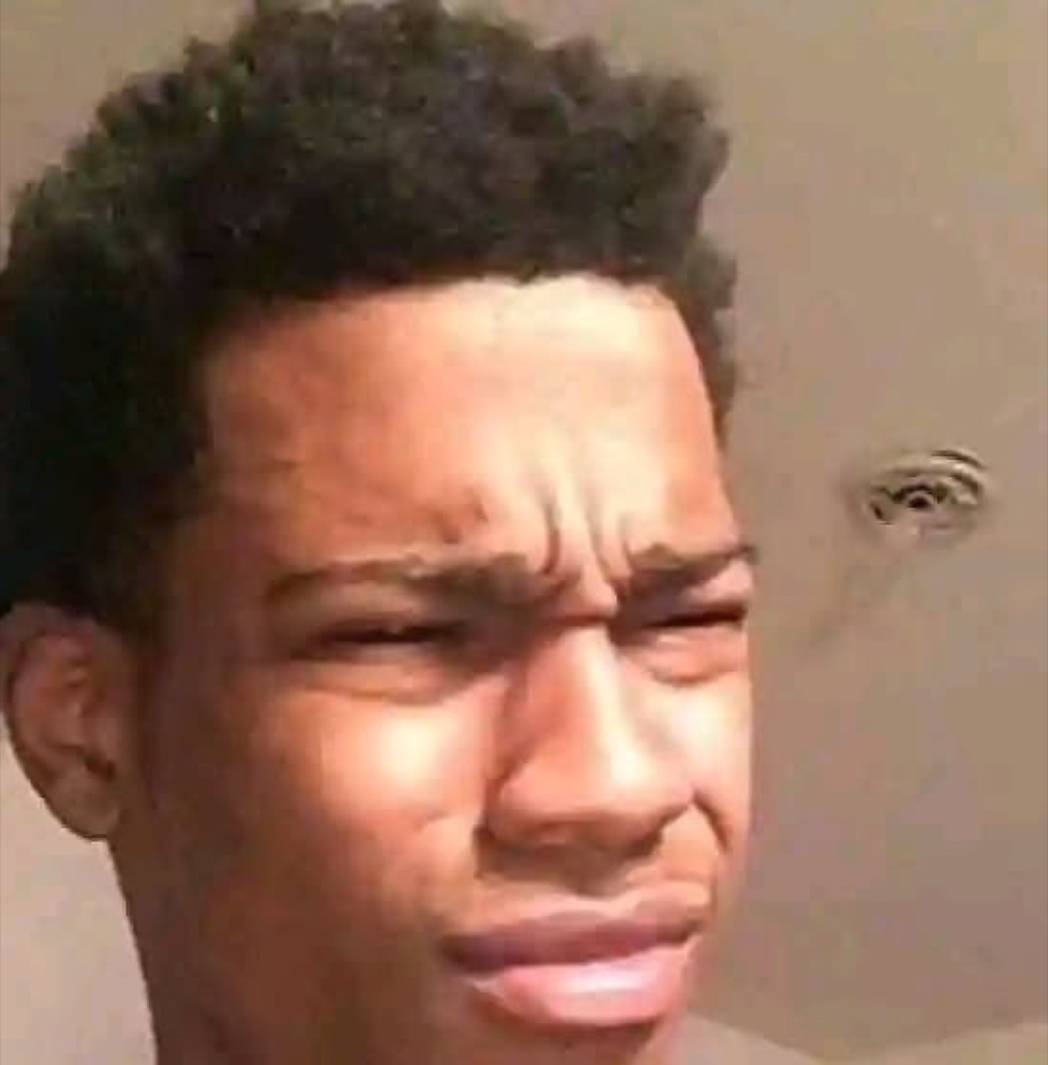 Guy squinting at the camera with a disgusted, confused what-is-this face