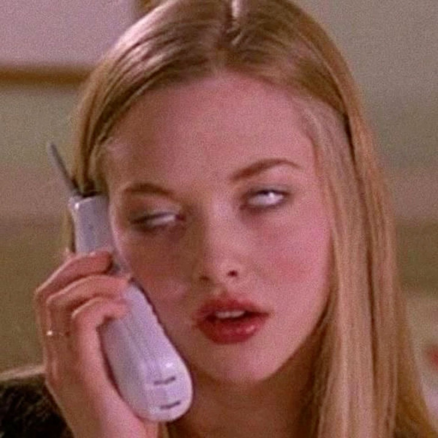 Blonde girl on a cordless phone with a blank, clueless expression
