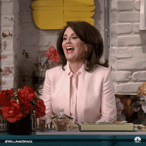 Megan Mullally as Karen Walker in Will & Grace clapping and squealing with delight