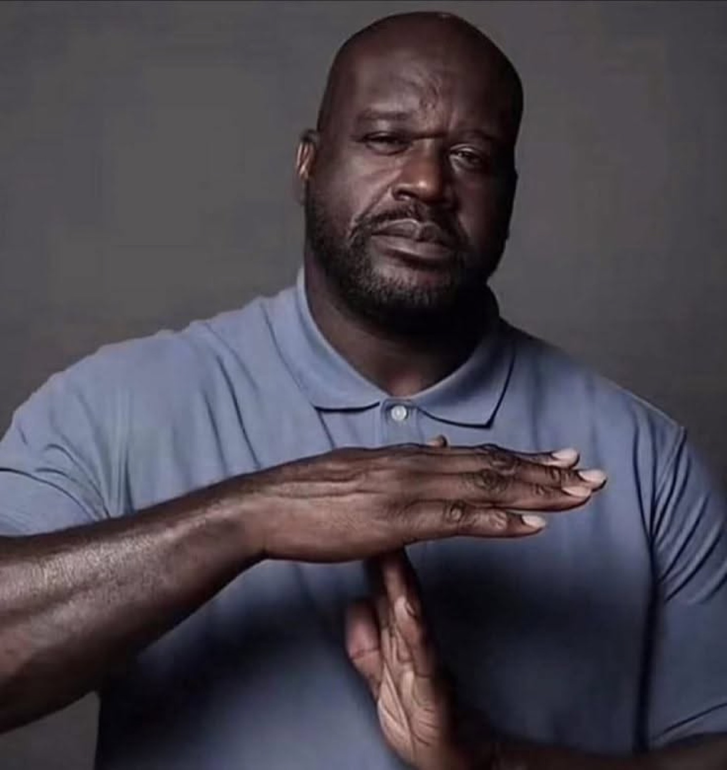 Shaquille O'Neal making a firm 'stop' gesture with both hands flat, completely done