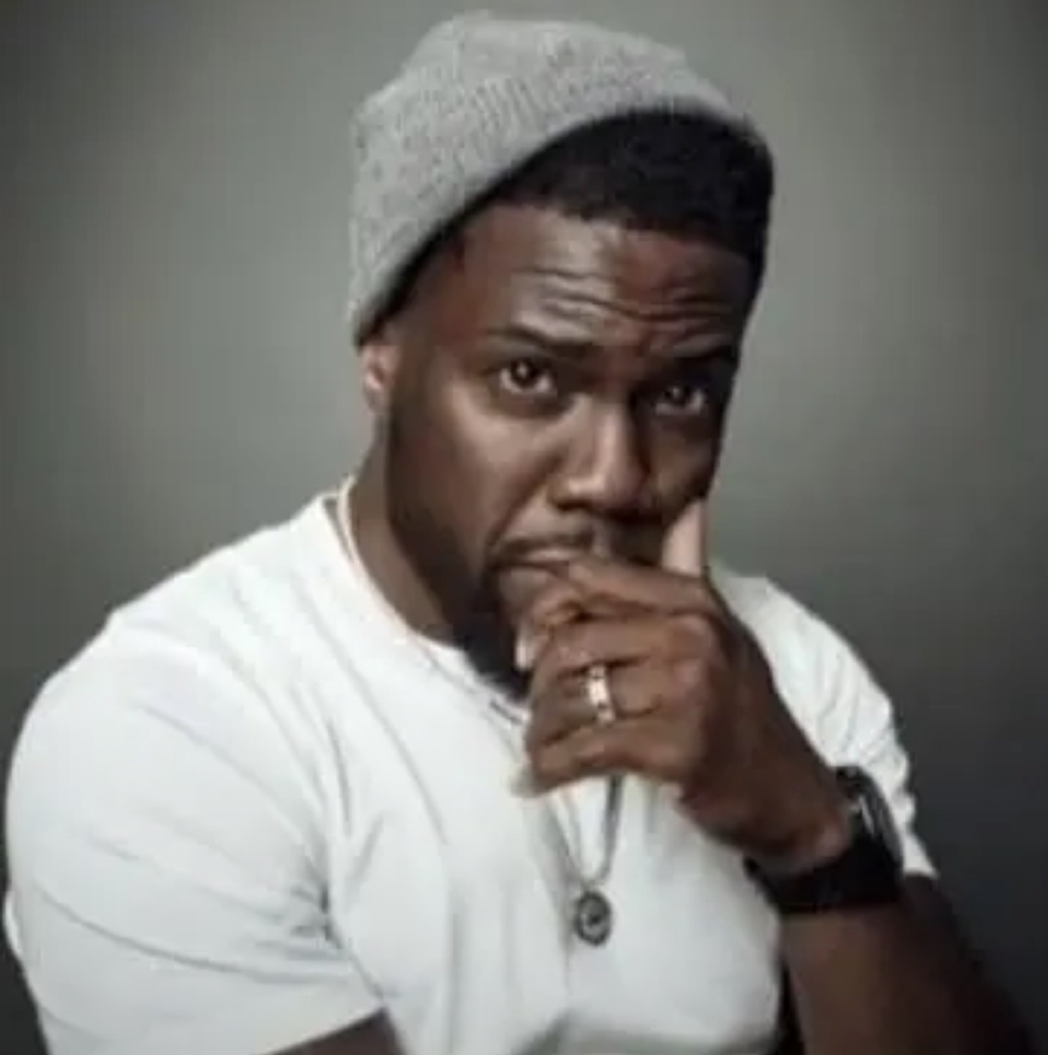 Kevin Hart with a hand on his chin, thinking