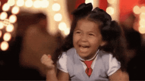 Little girl squealing and pumping her fists in excitement
