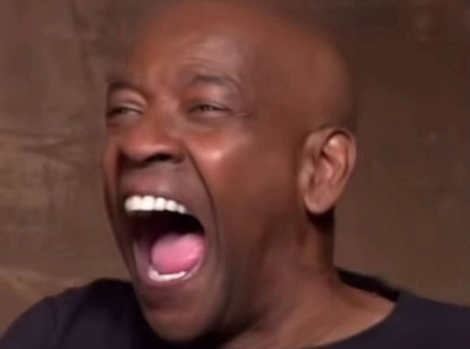 Man throwing his head back in a full wide-mouthed burst of laughter