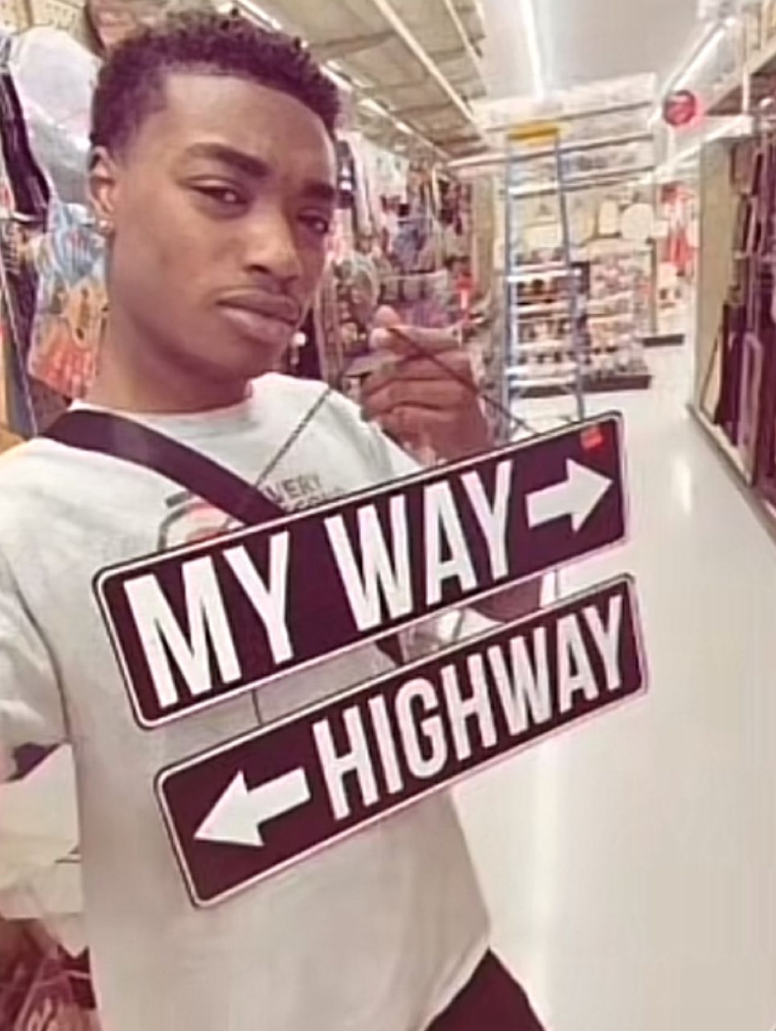 Guy holding 'MY WAY / HIGHWAY' signs