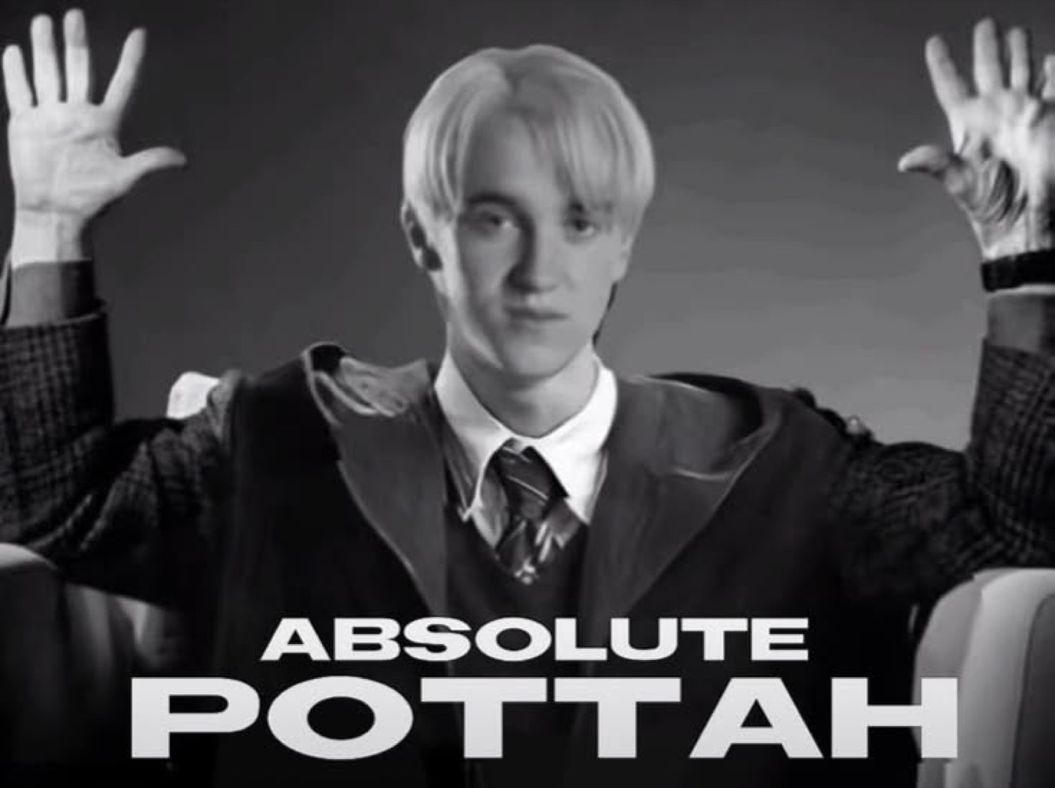Draco Malfoy with raised hands behind him under 'ABSOLUTE POTTAH'