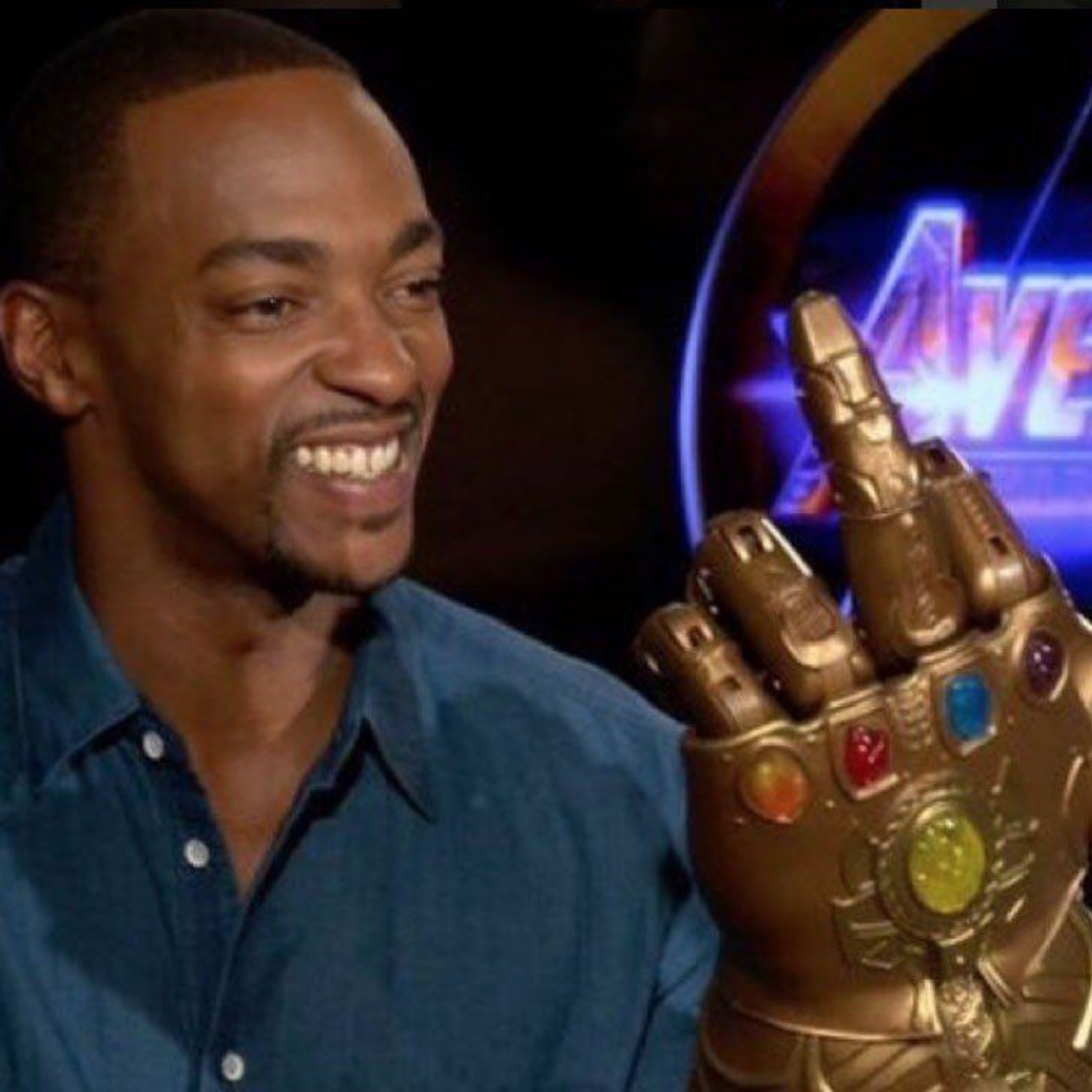 Anthony Mackie grinning ear to ear while trying on the Infinity Gauntlet at an Avengers interview