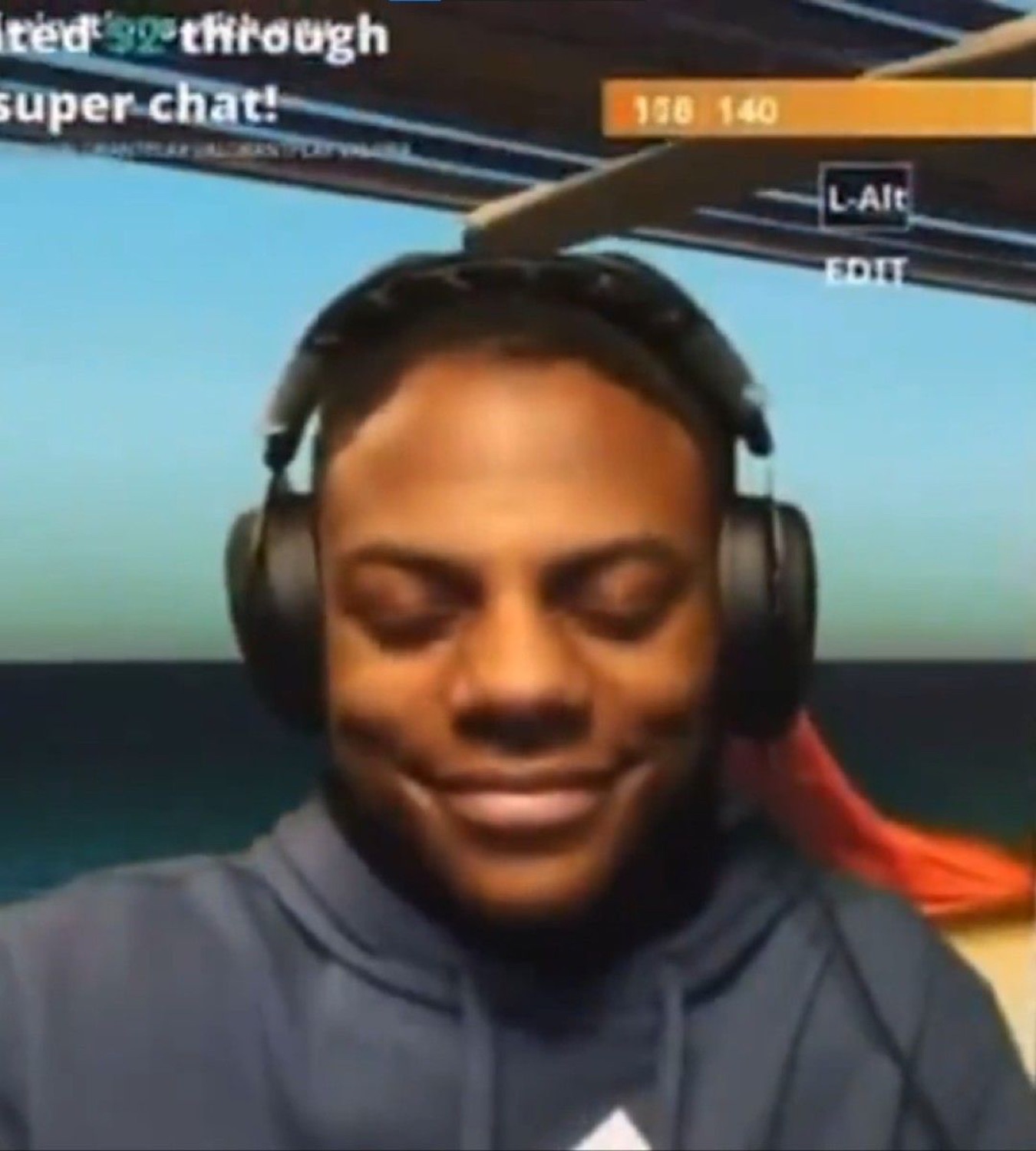 Streamer in headphones with eyes closed and a satisfied smirk while super chats roll in
