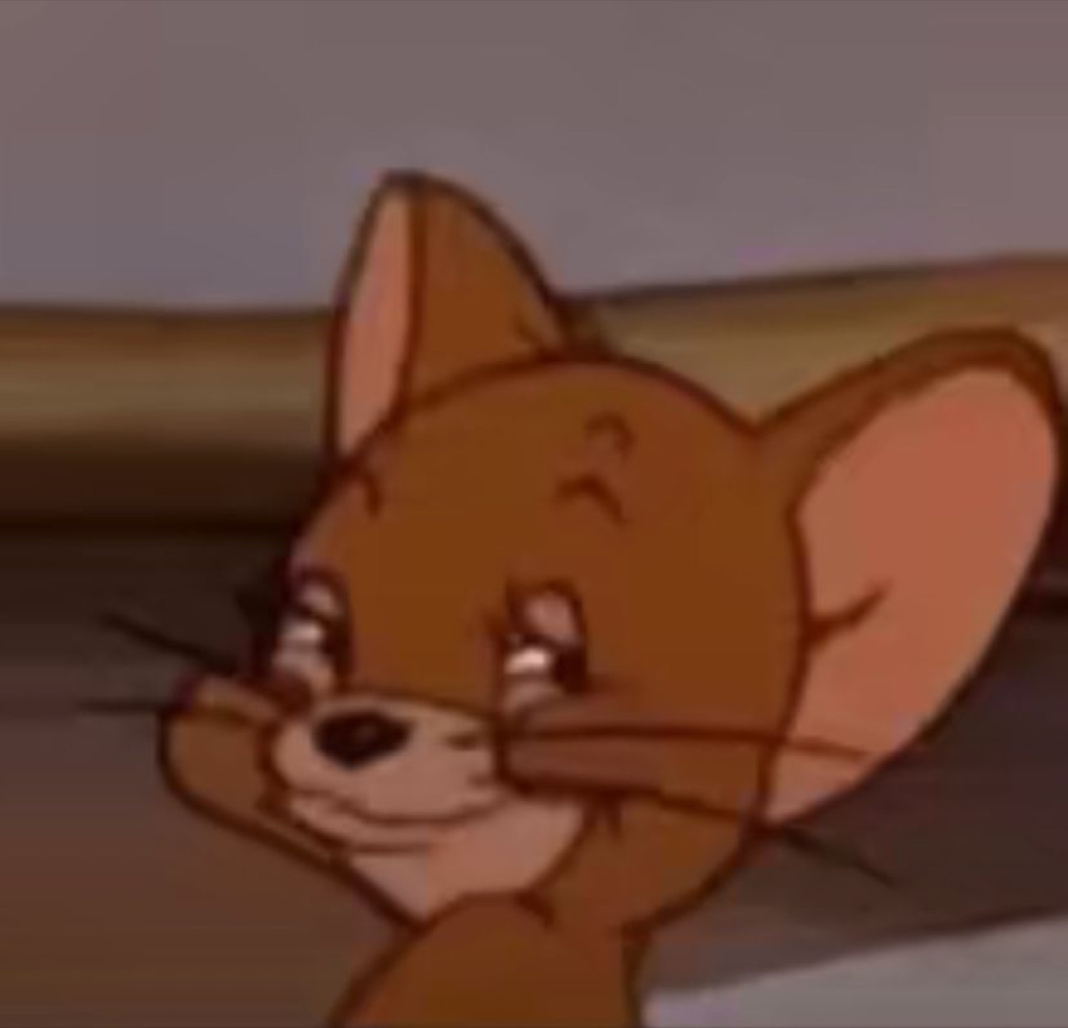 Jerry the mouse resting his chin on his paws with a smug, content little smile