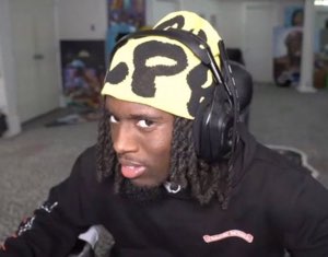 Streamer in a yellow P beanie and headphones giving you the most skeptical side-eye