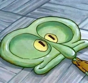 Squidward completely flattened on the floor, his face pressed flat with the most defeated look possible