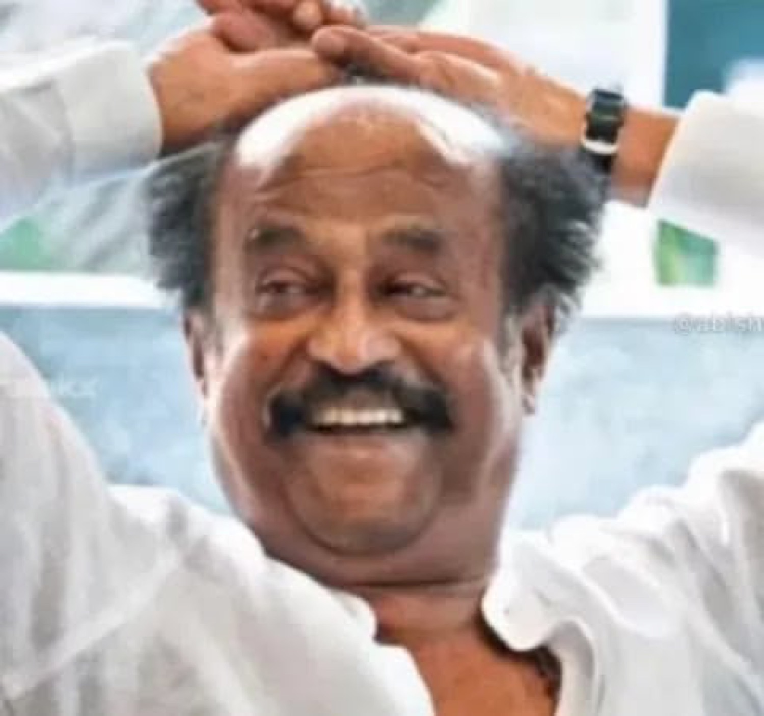 Rajinikanth laughing with his hands on his head