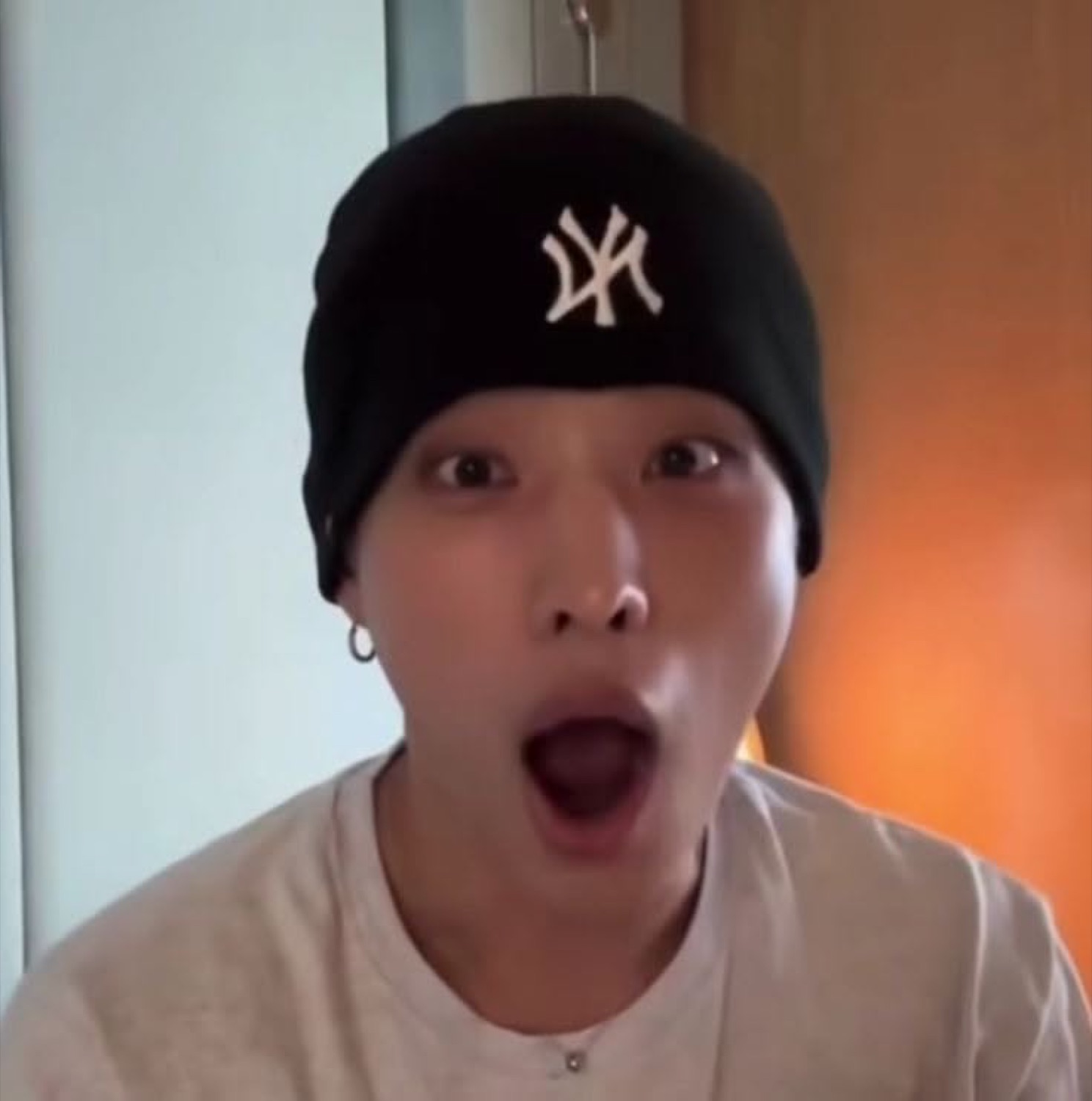 Guy in a black NY beanie with his eyes wide and jaw hanging open in shock